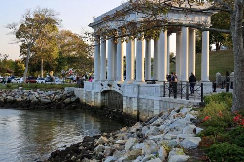 a group of people standing next to a river at Harbourtown Suites on Plymouth Harbor in Plymouth