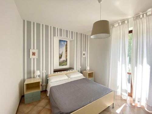 a bedroom with a bed and a large window at Il Casolare della Cascata in Terni