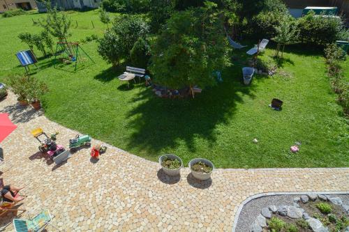 an aerial view of a backyard with plants and a playground at Ferienwohnung Sonnenhof in Andelsbuch