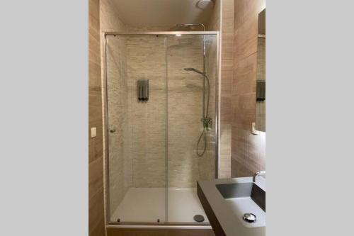 a bathroom with a shower and a sink at Gezellige vakantiewoning nabij Damme in Damme
