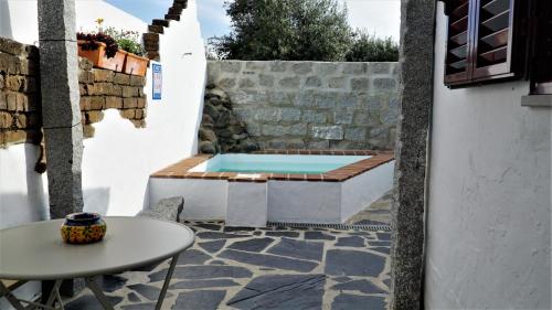 a patio with a hot tub and a table at 17 da Rua da Estação in São Pedro do Corval
