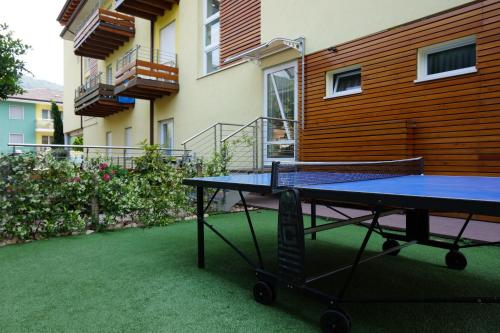 a ping pong table in front of a building at Residence Rivachiara (check-in at Hotel Riviera in Viale Rovereto, 95) in Riva del Garda