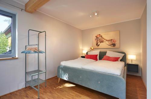 a bedroom with a bed with red pillows at Penthouse one in Wilnsdorf