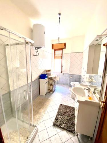 a bathroom with a shower and a sink and a toilet at White beach Le Castella in Le Castella