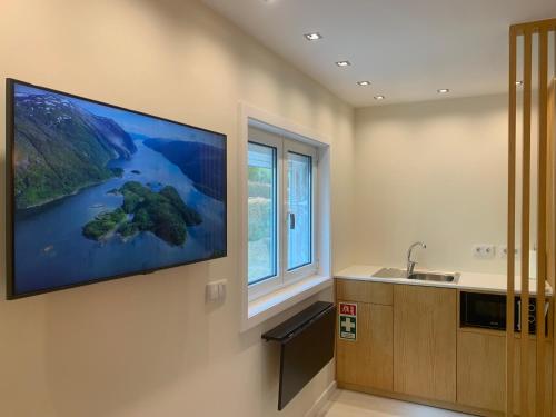 a large painting on the wall of a kitchen with a window at Merim Apartments in Ponte de Lima
