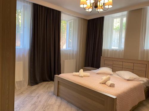 a bedroom with a bed with two towels on it at nikani in Borjomi