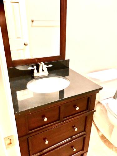 a bathroom sink with a mirror on top of it at Beech Mountain Cozy Condo in Beech Mountain