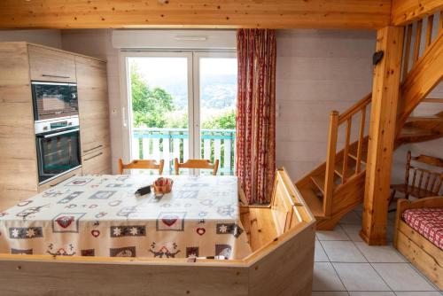a bedroom with a bed in a room with a balcony at Les Adrets in Gérardmer