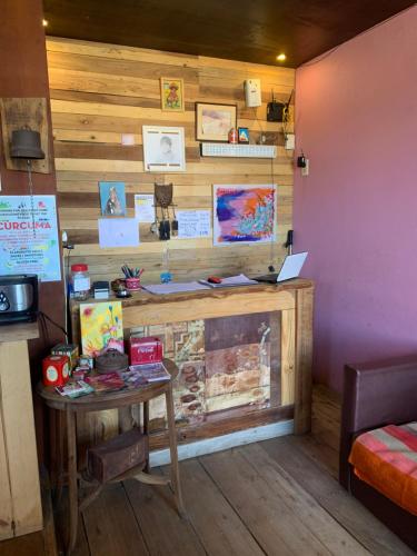 a room with a table and a laptop on a wall at Guanaca Lodge in El Chalten