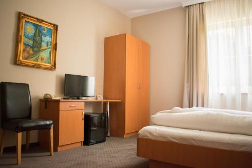 A television and/or entertainment centre at P4W Hotel Residence Szombathely