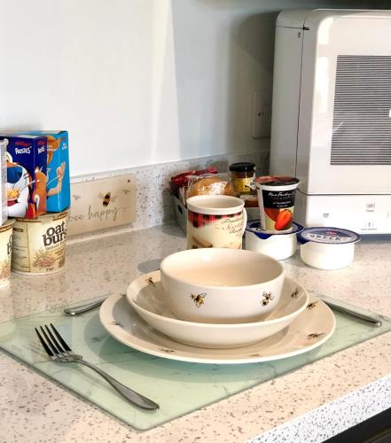 a bowl and plate sitting on a kitchen counter at Room on the River in Cruden Bay