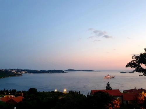 a boat on the water at sunset at Ardura shimmering on the sea in Mlini