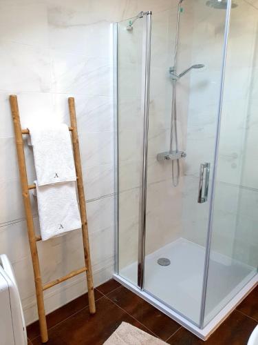 a shower stall with a glass door in a bathroom at Ardura shimmering on the sea in Mlini