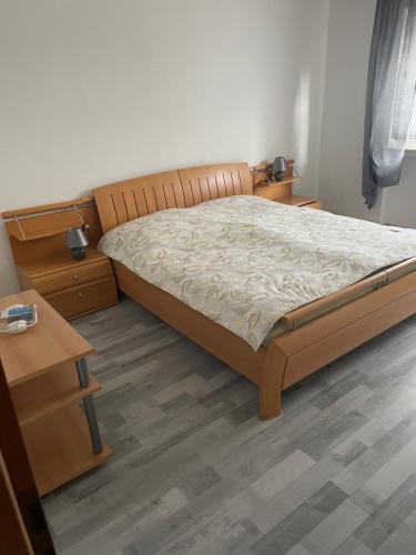 a bedroom with a bed and a wooden floor at Erlenstr. 17 35410 Hungen in Hungen