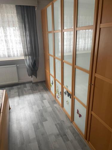 a room with some glass cabinets and a window at Erlenstr. 17 35410 Hungen in Hungen