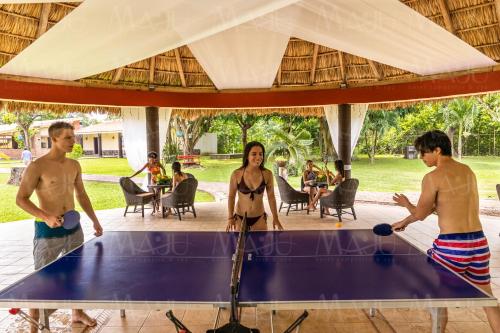 a group of people playing ping pong on a table at MAJU HOTEL CAMPESTRE & SPA in Jamapa