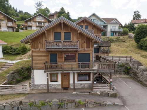a log house with a balcony and a porch at Les Adrets in Gérardmer