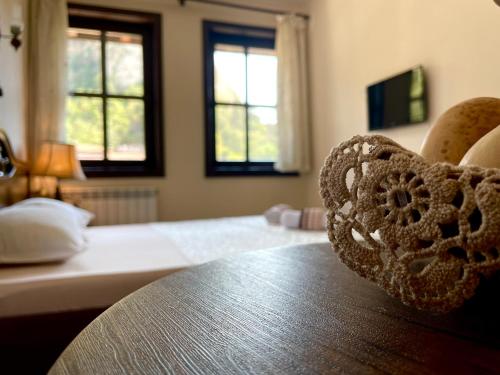 a bedroom with a bed and a wooden table at Hotel Slavova Krepost in Melnik