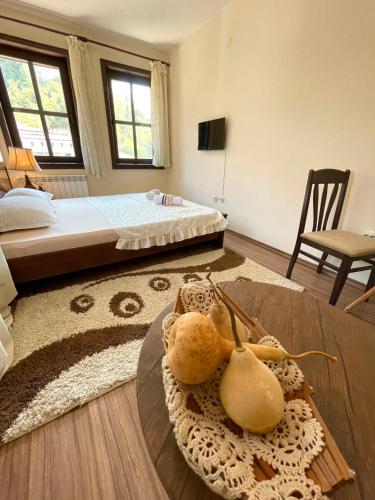 a room with a bed and a table with a animal on it at Hotel Slavova Krepost in Melnik