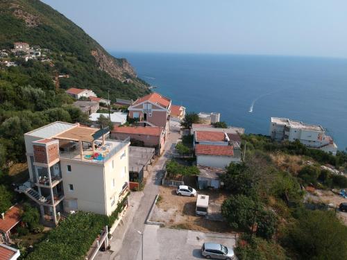 an aerial view of a town on a hill next to the water at Montenegrina Apartment in Budva