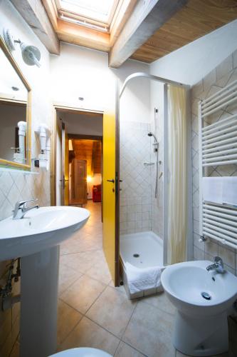 a bathroom with a sink and a toilet and a tub at Chalet Della Guida in Bardonecchia
