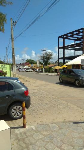 two cars are parked in a parking lot at Kitnet Clokel ap 104 A in Jacumã