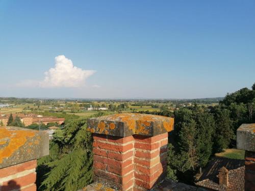 an old brick chimney on top of a building at Maison Tuscany Bed&Breakfast in Sinalunga
