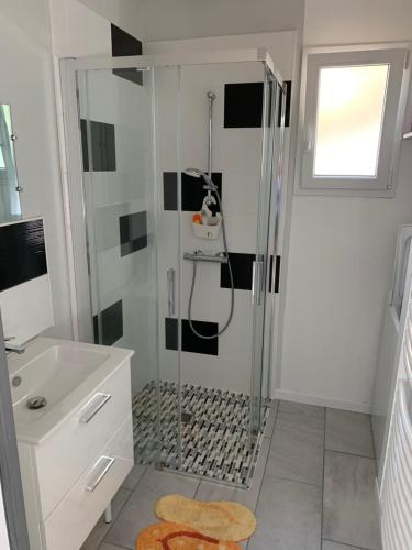 a white bathroom with a shower and a sink at Idéale famille, tout y est ! in Dompierre-sur-Besbre