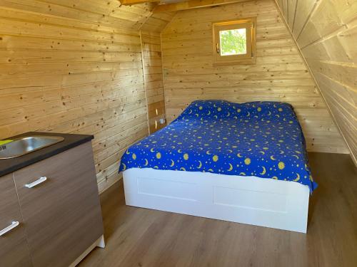a bedroom with a bed in a wooden cabin at Camp Din in Novigrad Istria