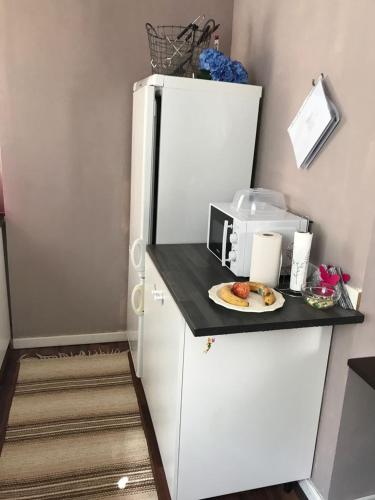 a white refrigerator with a plate of food on a counter at Vacker hus i naturen in Fröseke