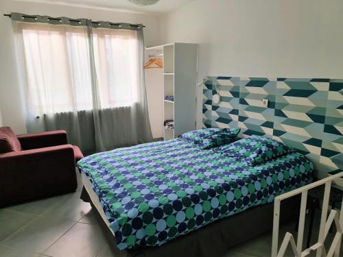 a bedroom with a bed with a blue and white comforter at Gite de Circourt in Buxières-sous-les-Côtes