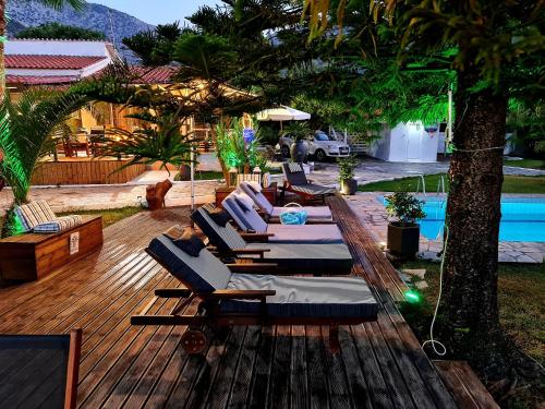 une terrasse avec des chaises longues et une piscine dans l'établissement Villa Gala, à Balíon