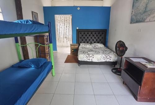 a bedroom with two bunk beds and a table at Galerazambahostal in Galerazamba