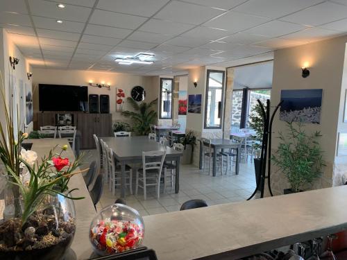 a restaurant with tables and chairs in a room at Auberge de la Tour in Freycenet-la-Tour