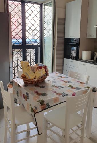 a kitchen with a table with a basket on it at SPARTA in Ercolano