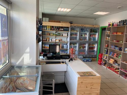 a shop with a counter with a computer on it at Auberge de la Tour in Freycenet-la-Tour