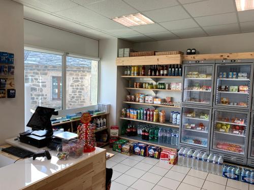 a room with a counter and shelves with drinks at Auberge de la Tour in Freycenet-la-Tour