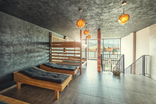 a room with two beds and a staircase with windows at Aparthotel Central Liptovský Mikuláš in Liptovský Mikuláš