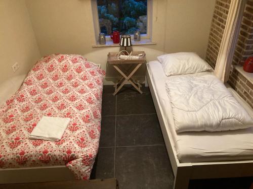 En eller flere senge i et værelse på Vakantiehuis In het Voorhuis