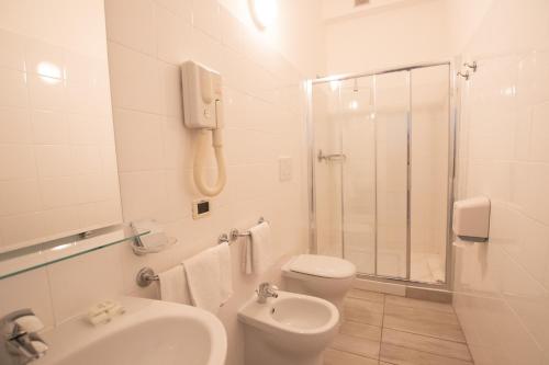 a bathroom with a sink and a toilet and a shower at Piccolo Hotel in Ravenna