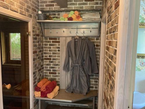 a closet with a coat hanging in a brick wall at Estere in Cēsis
