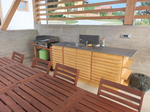 an outdoor kitchen with a sink and a stove at Hiša sonca Toti breg in Svečina