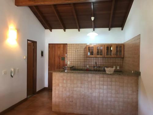 a kitchen with a sink and a counter top at Pousada OAK Plaza in Monte Verde
