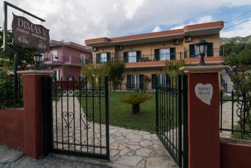 a gate with a sign in front of a building at Nature & Blue in Parga