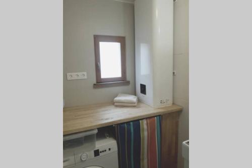 a bathroom with a wooden counter top and a mirror at Maison de pêcheur près du port in Étaples