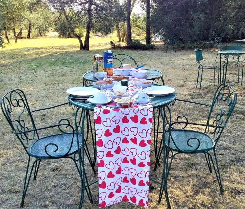 a table with a red and white table cloth on it at Sunshine Suites in Florence