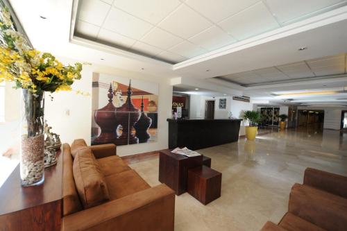 a living room with a couch and a table at Imperio de Angeles Executive León Poliforum in León