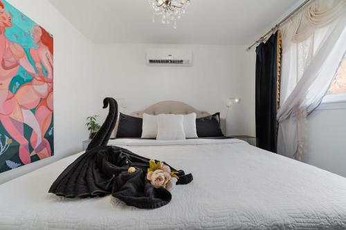 a bedroom with a bed with a black dress on it at Villa Sierra in Sonora