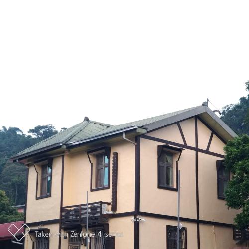 a house with a gray roof and windows at 星月澄嵐 in Yuchi