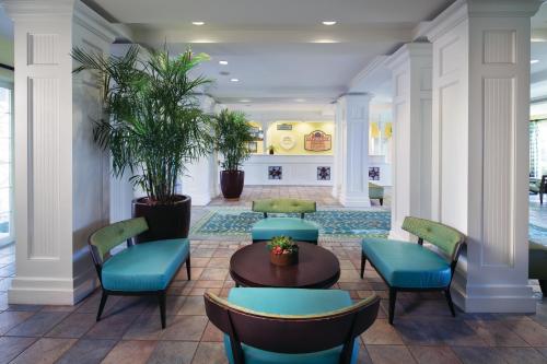 a lobby with blue chairs and a table at Harborside Atlantis in Nassau
